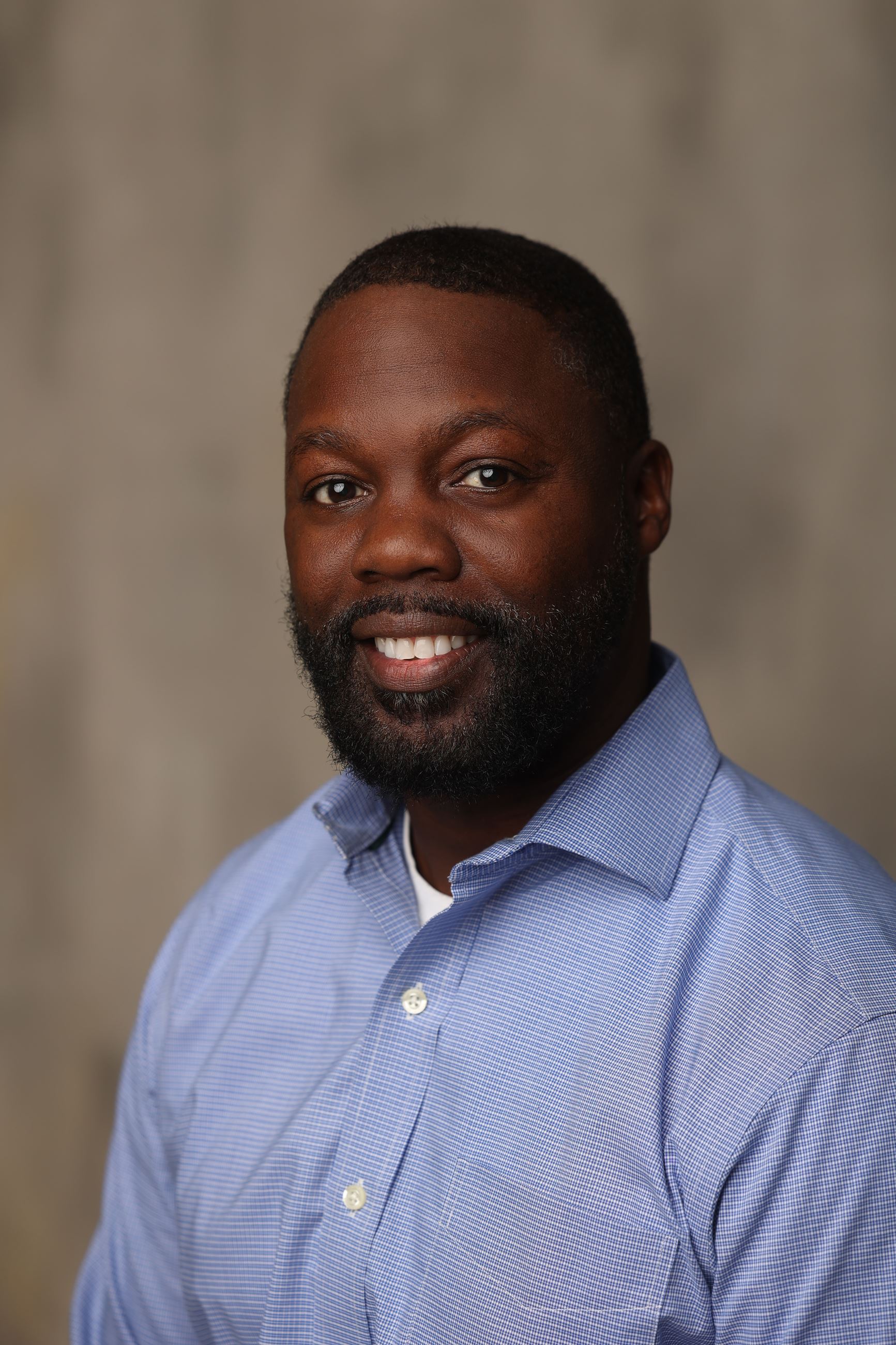 Photo of an African American Male in a blue shirt 