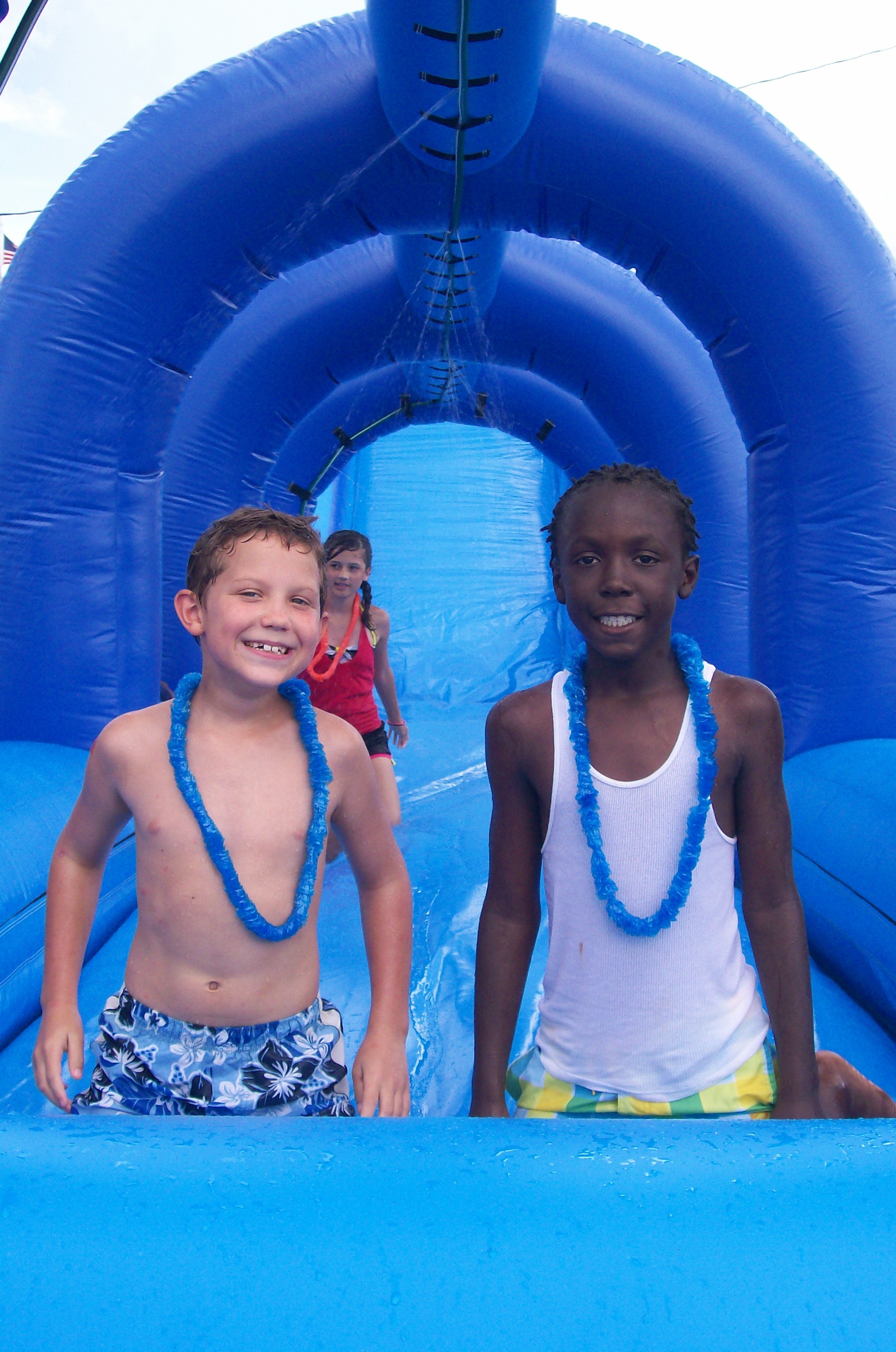 Two local youths enjoy waterslide
